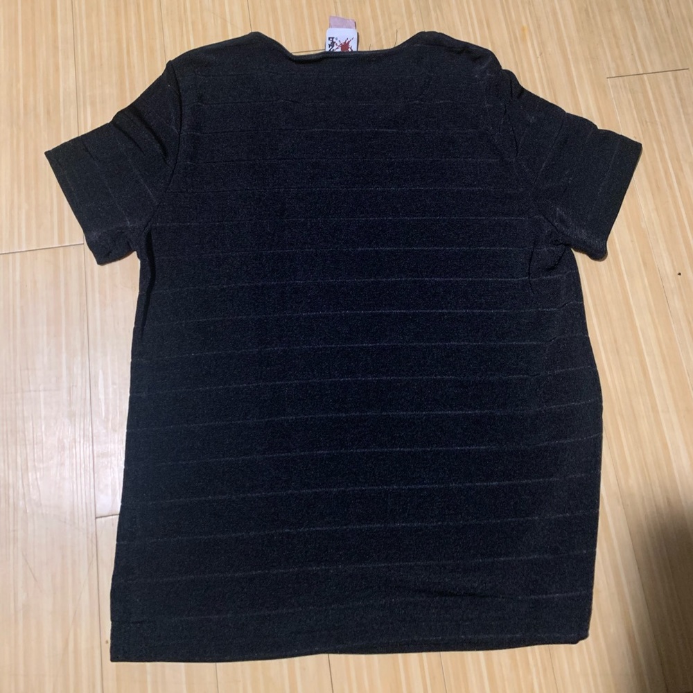 Black polyester stretchy shirt. Can be dressed up, or worn as is. Tight fitting.